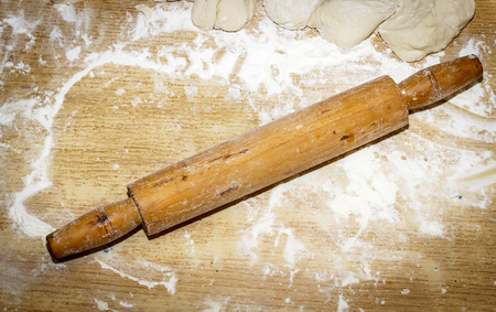 cooking, baking and home concept - close up of bread dough and utensils on cutting boardの写真素材