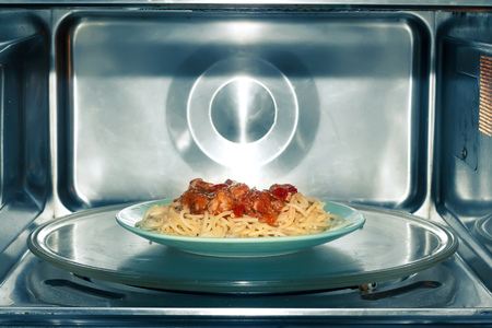 Spaghetti with tomato-meat sauce in microwave ovenの写真素材