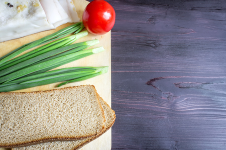 Lard Salo , green onions, bread, red tomato on a wooden background.の写真素材