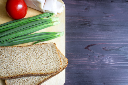 Lard (Salo), green onions, bread, red tomato on a wooden background.の写真素材