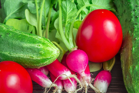 Vegetables close up. Cucumber, tomatoes, radish. Close up with selective focus.の写真素材