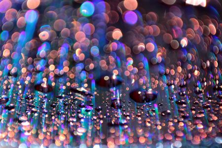 Multicolored water droplets close-up. Beautiful bokeh.の写真素材