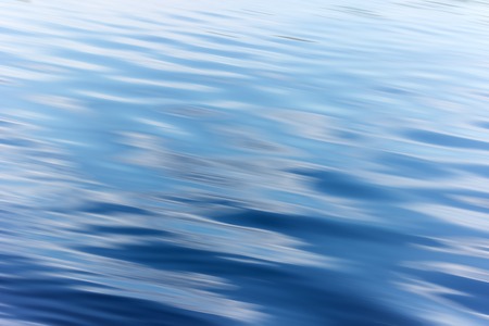 blue water background with ripples Sea low angle view, river, wave. Close up Nature background. Soft...