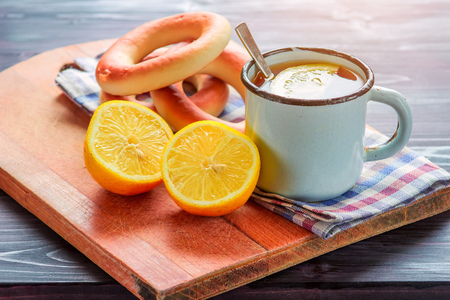 Tea with lemon and bread on a wooden tableの写真素材