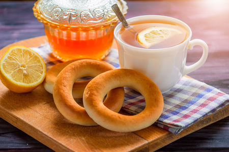 Tea with lemon and bread on a wooden tableの写真素材