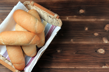 Fresh bread on wooden table. Top view with space for your textの写真素材