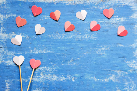 Red hearts on a blue wooden table. Valentines day background.の写真素材