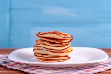Stack of pancakes on blue backgroundの写真素材