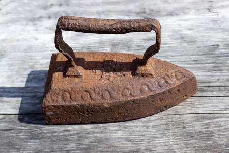 Vintage iron on a wooden table.