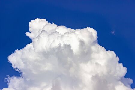 Fantastic white clouds against blue summer skyの写真素材