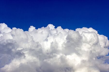 Fantastic white clouds against blue summer skyの写真素材