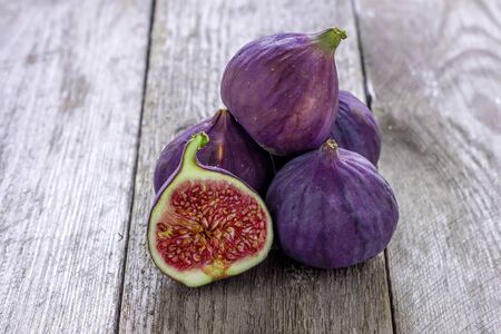 A fresh figs on old wooden background.