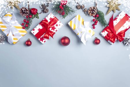 Christmas gifts on a blue background and snow on the edges, top view.の写真素材