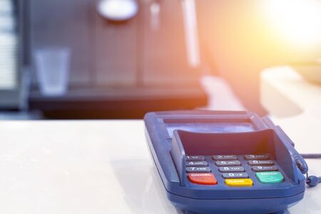 Payment terminal on table in restaurant. Financial concept.
