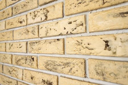 Yellow brick wall closeup. Abstract backgroundの写真素材