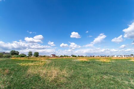 Summer landscape with green grass. Field and clouds. Rural summer landscapeの写真素材