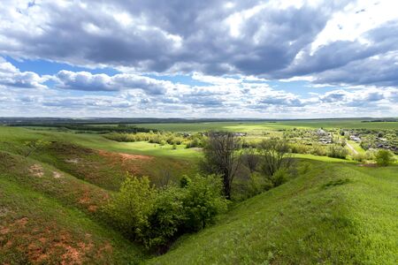 Green hills against the blue sky with clouds.の写真素材