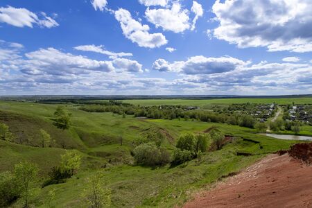 Green hills against the blue sky with clouds. Beautiful screensaverの写真素材