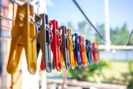 Colorful clothespin on the hangers. Plastic clothespins in different colors.の写真素材