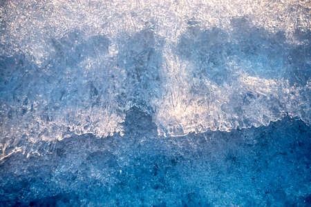 The texture of the snow glows beautifully in the setting sun.の写真素材