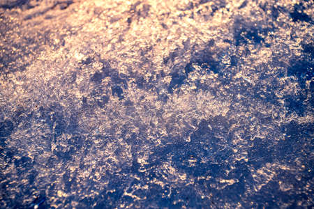 The texture of the snow glows beautifully in the setting sun.の写真素材