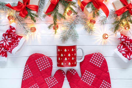 Christmas decoration of fir branches, New Year's lanterns and gifts on a white wooden background....
