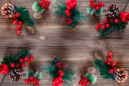 Christmas decoration with pine branches, cones and red berries. Top view. Flat layの写真素材