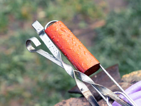 Skewer and grate handle for grilling meat on a rainy day. Kebabs are canceled due to rain.の写真素材