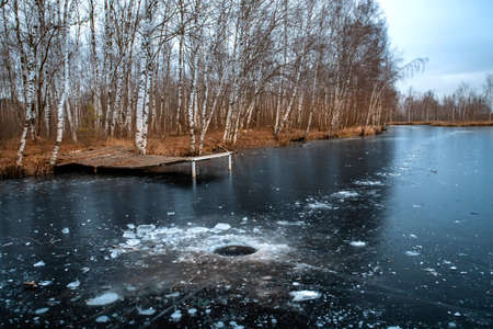 Frozen lake on an autumn dayの写真素材