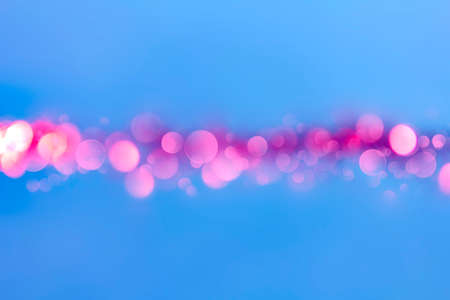 Abstract blue background with red round bokeh in the centerの写真素材