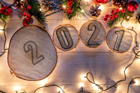 Wooden stump with happy new year decoration. Round cut down tree with annual rings as a wood texture