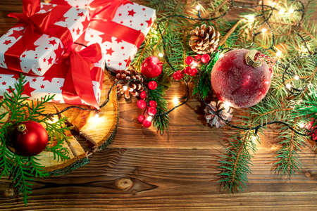 Christmas decoration with spruce branches with a red ball and a garland. Winter holiday light decorationの写真素材