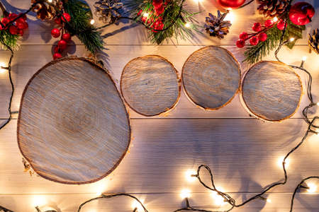 Wooden stump with happy new year decoration. Round cut down tree with annual rings as a wood textureの写真素材