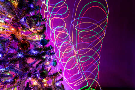 Christmas tree with lights and an inscription with light on a long exposureの写真素材
