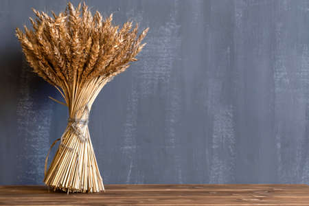 a bouquet of wheat ears on black background. Concept for cafe menuの写真素材