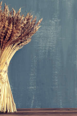 a bouquet of wheat ears on black background. Concept for cafe menuの写真素材