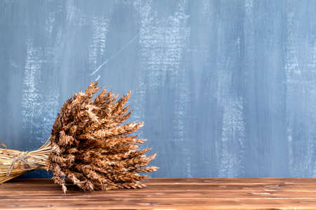 a bouquet of wheat ears on black background. Concept for cafe menuの写真素材