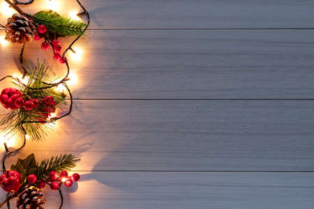 Christmas decoration with pine branches, cones and red berries. Top view. Flat layの写真素材