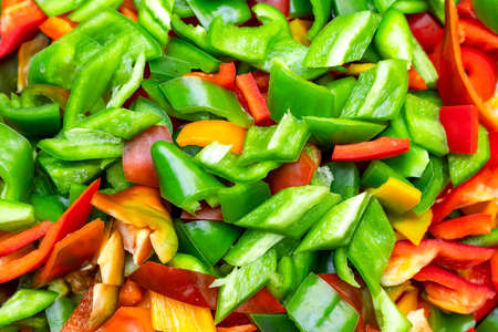 Background of multicolored sliced peppers. Top view.の写真素材