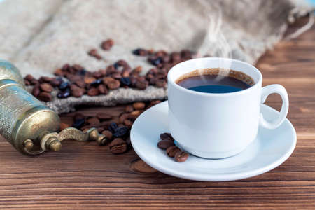 A cup of coffee with steam on the table. Planning and starting the day.の写真素材