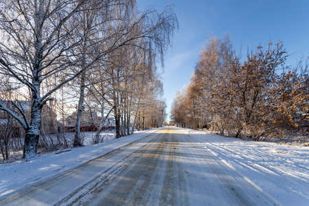 Empty snow covered road in winter landscape. Road in the winter timeの写真素材