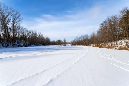 Sun, snow and Ski track crossing a frozen lake. Winter sportの写真素材