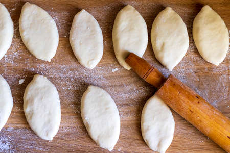Dough mold with rolling pin for making homemade pies. View from above. Home cooking concept