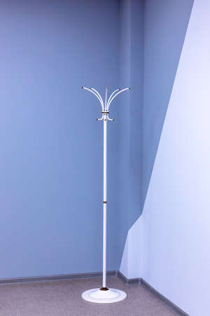 An empty coat rack stands on the floor in office. Vertical viewの写真素材