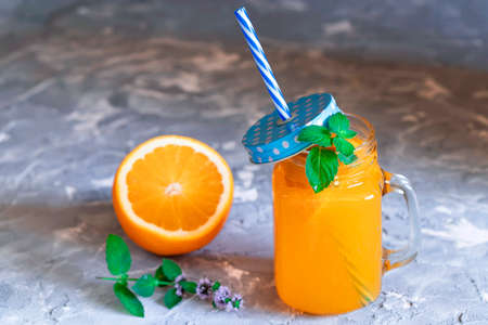 Refreshing fruit smoothie with mint leaves on dark tableの写真素材