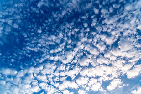 Blue sky with white clouds in sunny summer day.