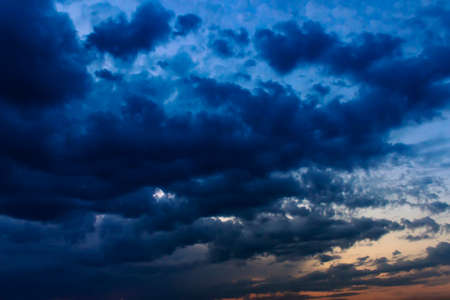 The big powerful storm clouds before a thunder-storm. Storm clouds at sunsetの写真素材