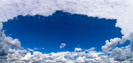 Blue sky background with white cloudsの写真素材