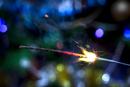 Holiday background with a sparklerの写真素材
