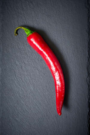 Red chilli pepper on a dark stone background. Top viewの写真素材